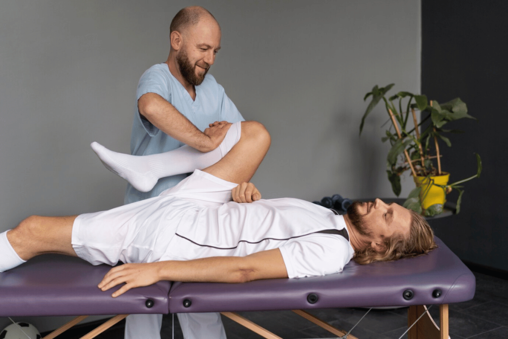 Physiotherapist working with a person on a massage table.