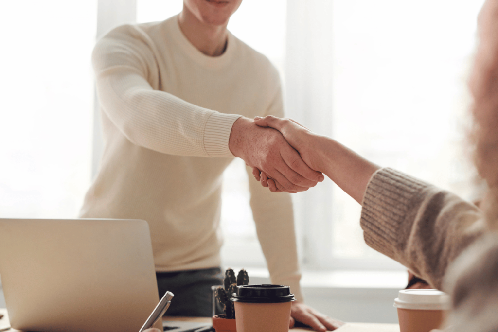 Close-up of a business handshake in office.